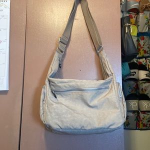 Kipling. 101/2 long x 9 high x 5 deep. New, no tags, beige. Perfect condition.